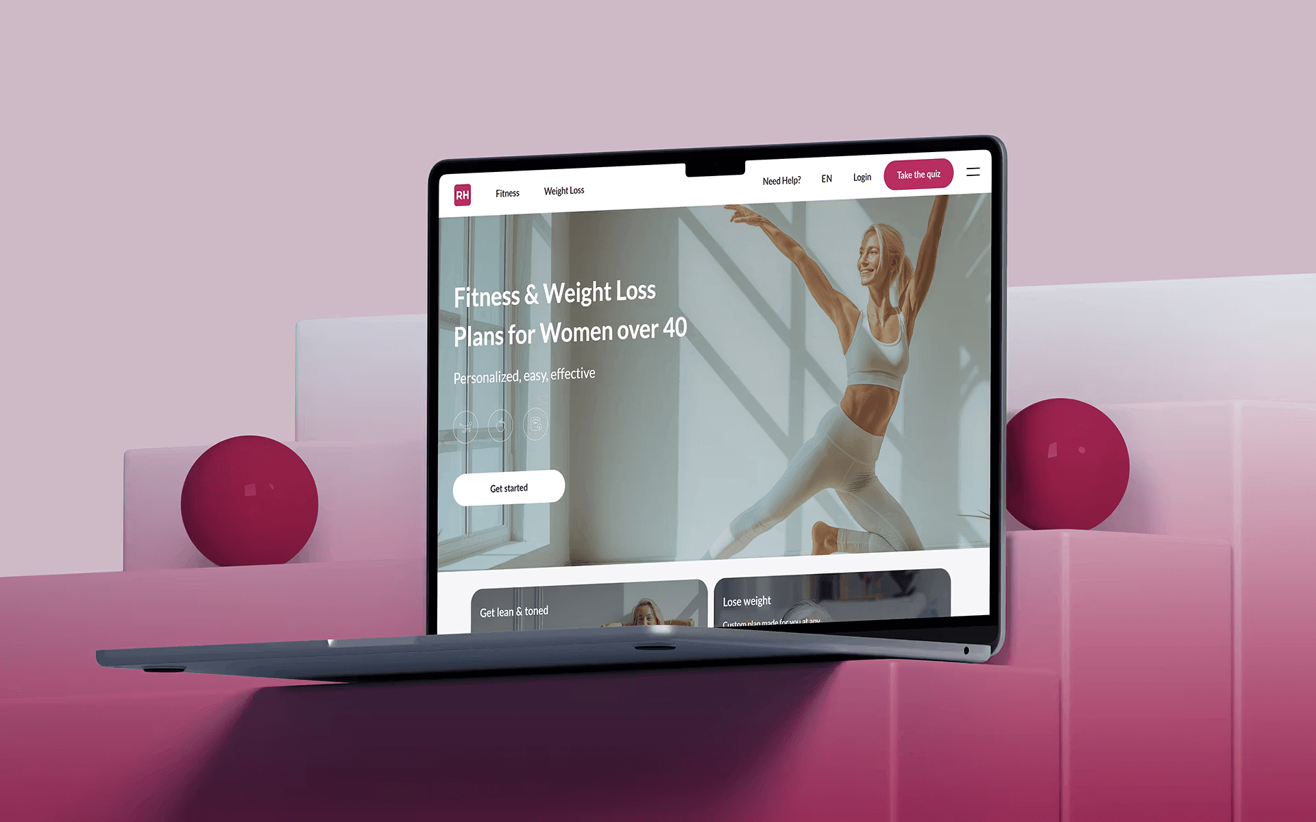 Laptop showing fitness and weight loss website for women with pink accents
