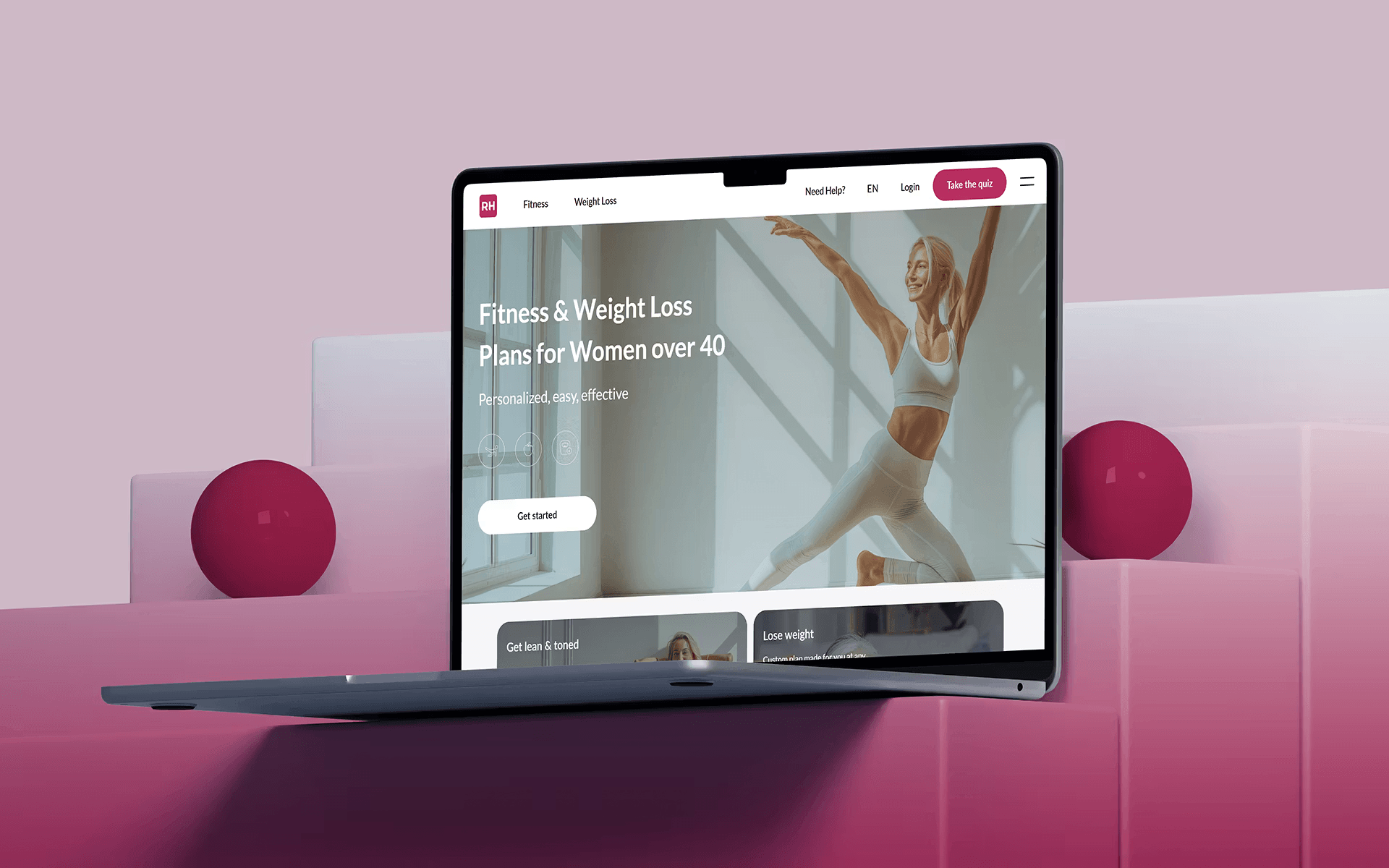 Laptop showing fitness and weight loss website for women with pink accents