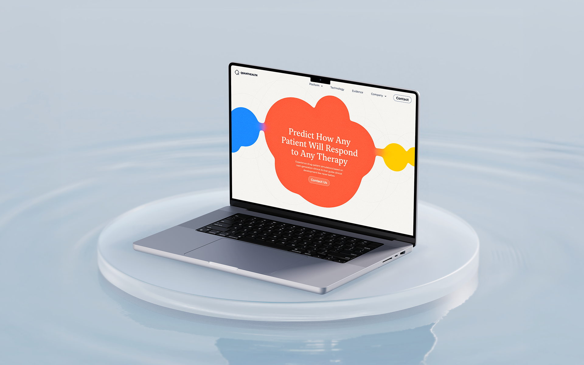 Laptop on reflective surface showing QuantHealth website with colorful blobs
