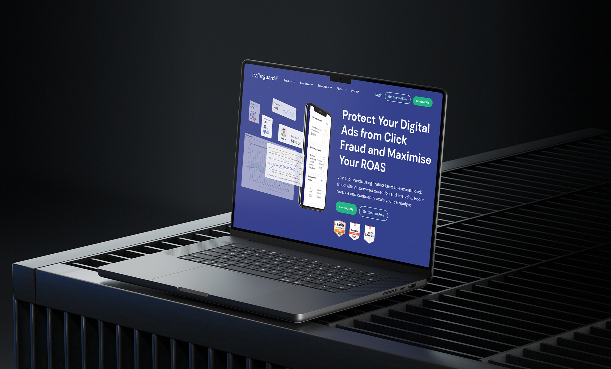 Laptop on dark surface showing TrafficGuard digital ad fraud protection site
