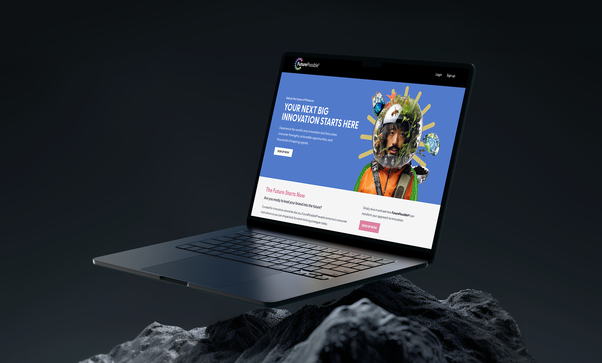 Laptop on dark rocky surface showing a creative agency website